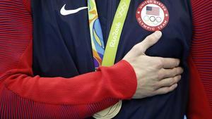 Michael Phelps se lleva la mano al pecho mientras suena el himno de EEUU, tras el triunfo en el relevo 4x100. La última de sus 28 medallas olímpicas.