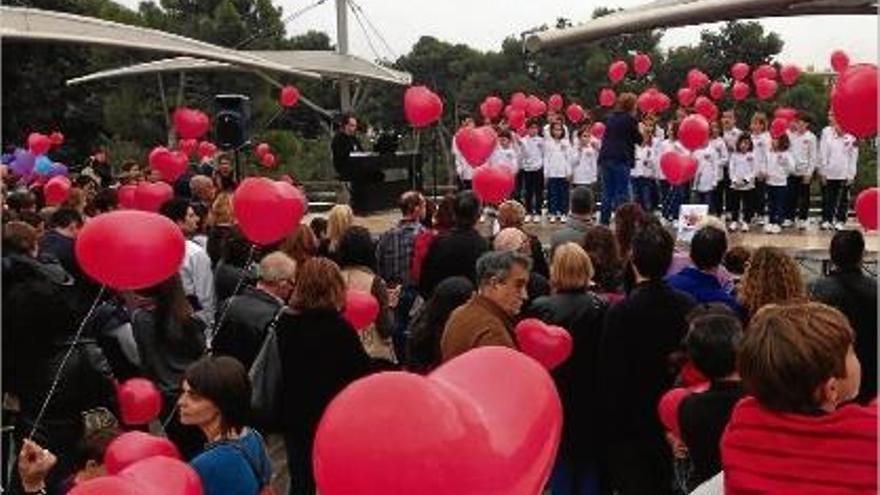 Els participants a la cadena humana &quot;Fem enlairar els cors&quot; amb els globus, durant una de les activitats.