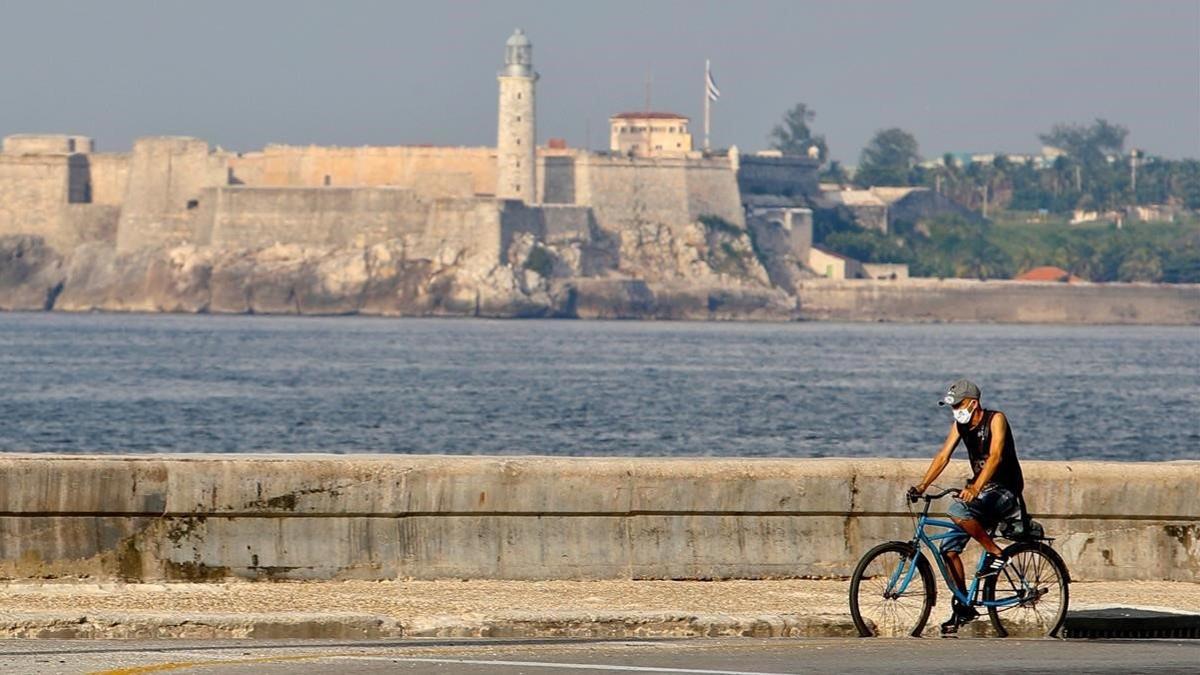 Un hombre pasa con su bici por el malecón de La Habana, el 21 de agosto del 2020