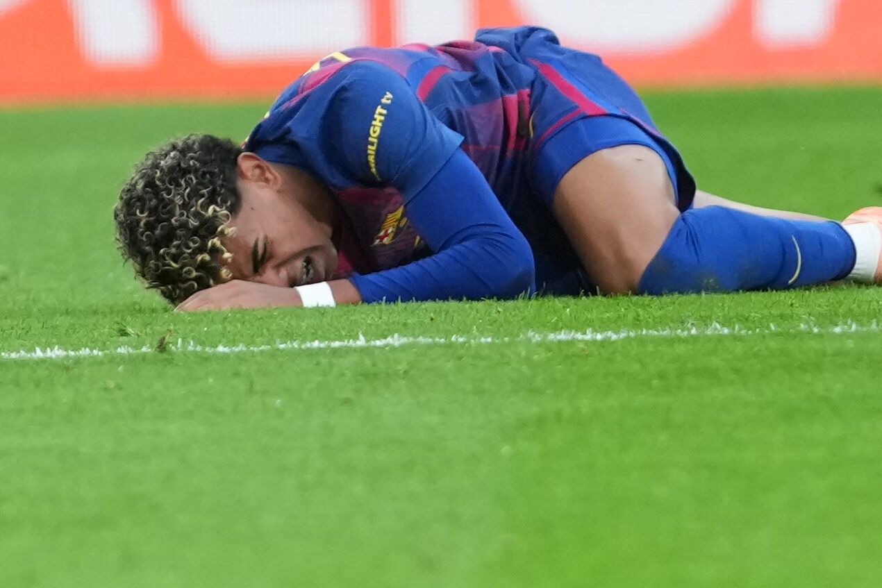 Barcelona's Lamine Yamal lies on the pitch in pain during the Spanish La Liga soccer match between Villarreal and Barcelona in Villarreal, Spain, Sunday, Dec. 21, 2025. (AP Photo/Alberto Saiz)