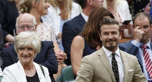 Former England soccer captain David Beckham sits with his mother Sandra on Centre Court at the Wimbledon Tennis Championships, in London