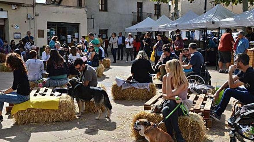 Famílies assegudes ahir a l&#039;entorn central de la nova fira de Montmajor Tocats pels Bolets