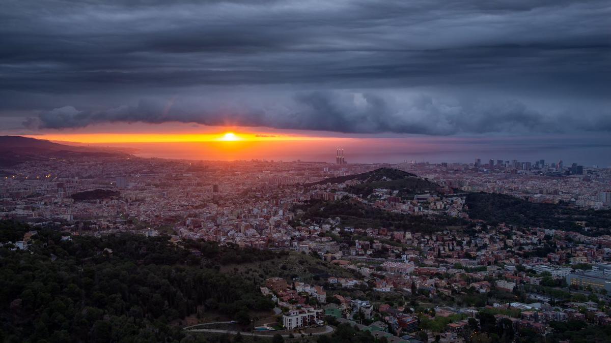El sol asoma bajo una masa de nubes en Barcelona