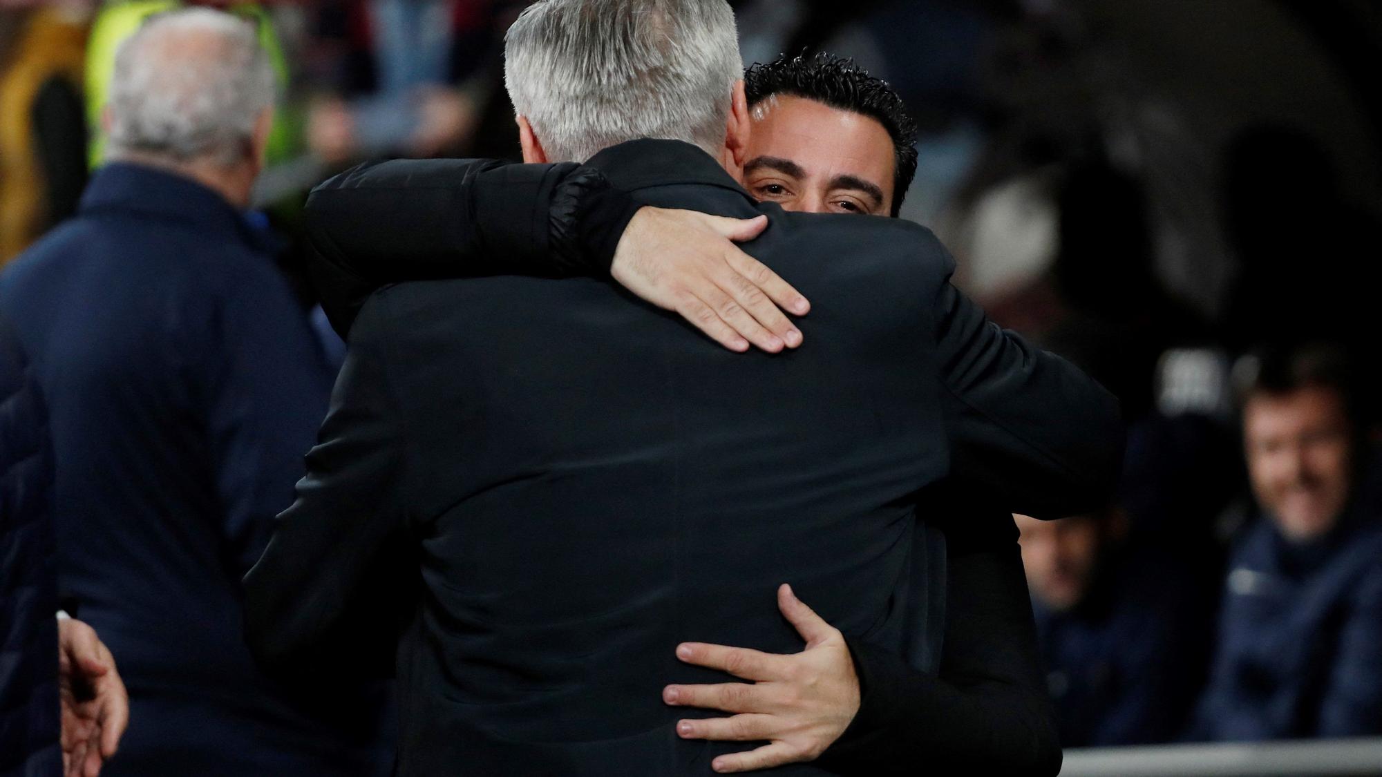 Xavi Hernández y Carlo Ancelotti se abrazan en el clásico de este domingo en el Bernabéu.