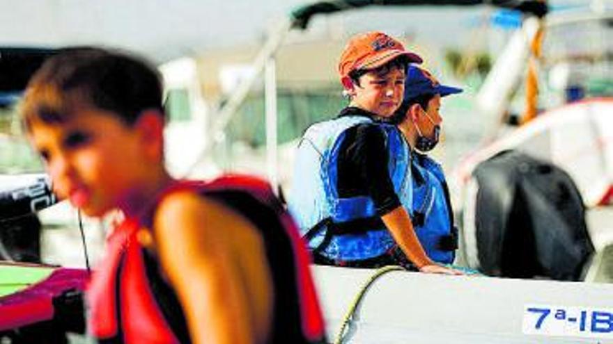 Varios niños a bordo de una lancha a punto de partir.  | TONI ESCOBAR