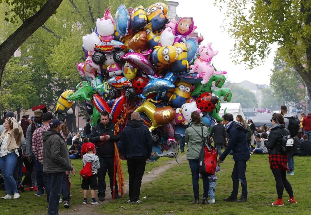 People walk through a park at the traditional ...