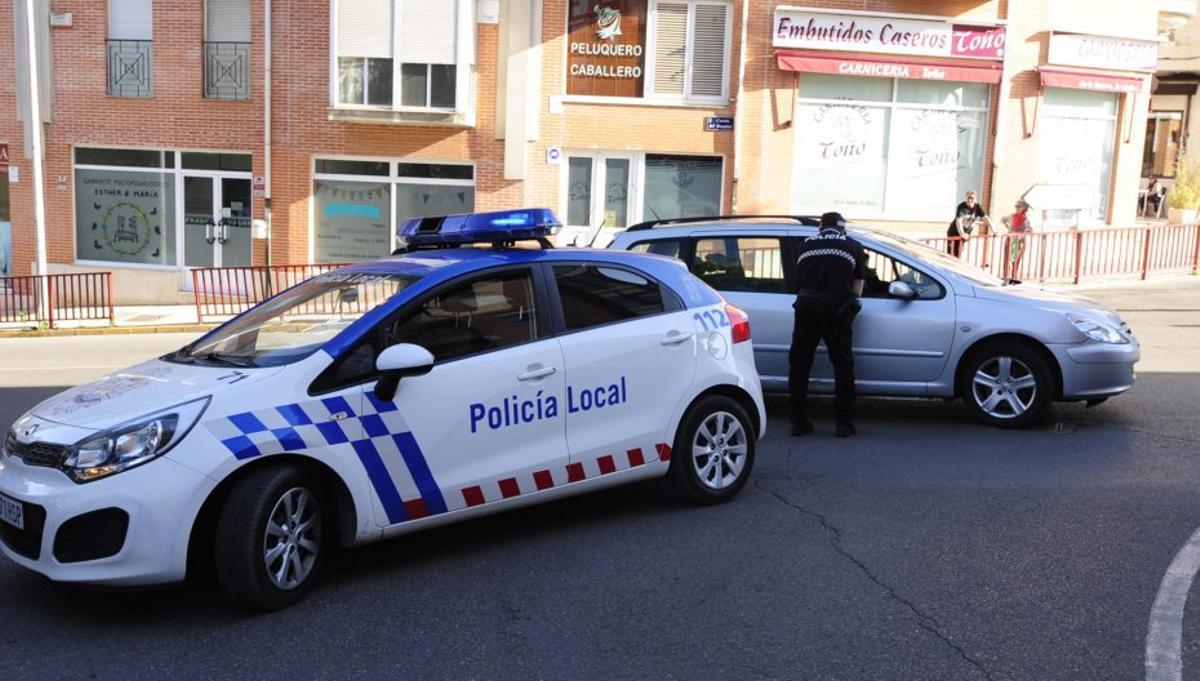 Un agente da indicaciones al conductor de un vehículo.