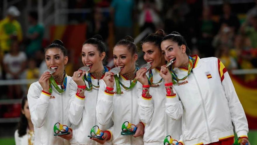 El quinteto español muerde sus medallas en el podio.