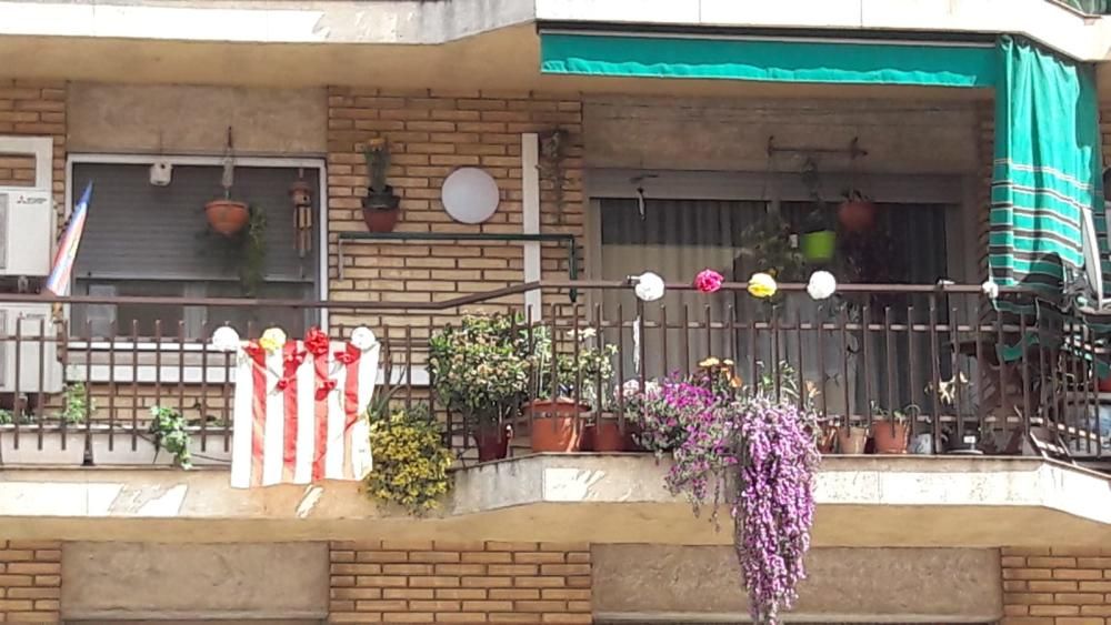 Veïns del carrer de la Pau decoren els balcons per Sant Jordi