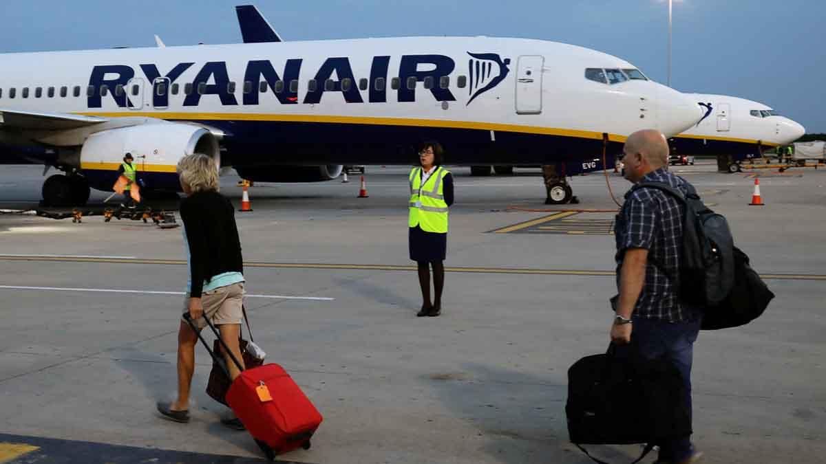 Pasajeros se dirijen a un avión de la compañia Ryanair en un aeropuerto de Londres