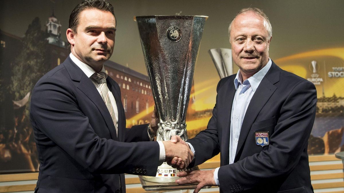 El director deportivo del Ajax Amsterdam, Marc Overmars (i), estrecha la mano a Bernard Lacombe (d).