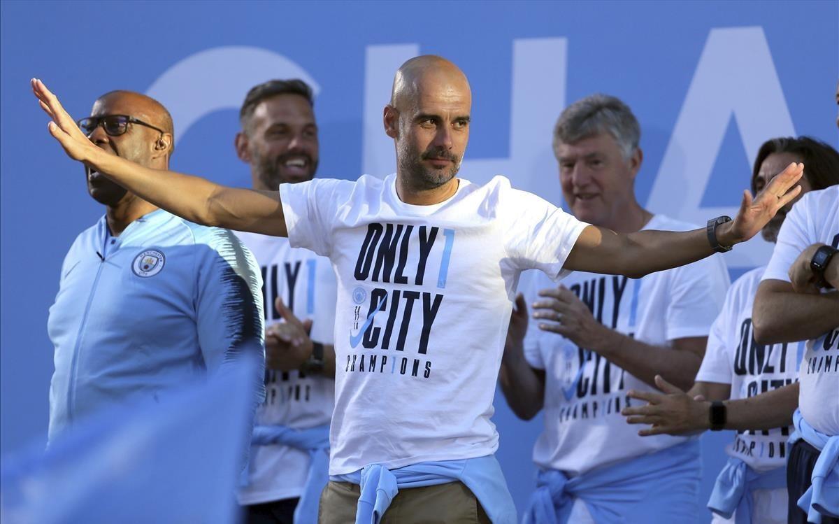 Guardiola festeja su primera Premier por las calles de Manchester.