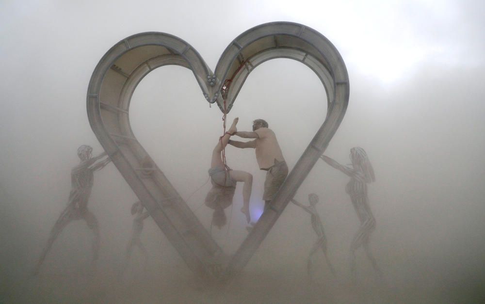 Burning Man participants perform a shibari rope ...