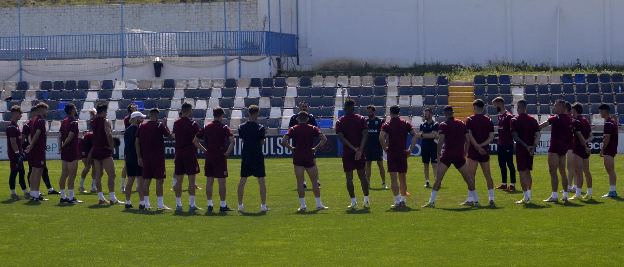 Los jugadores del Mérida atienden las indicaciones de Juanma Barrero durante el entrenamiento de ayer en Alicante.