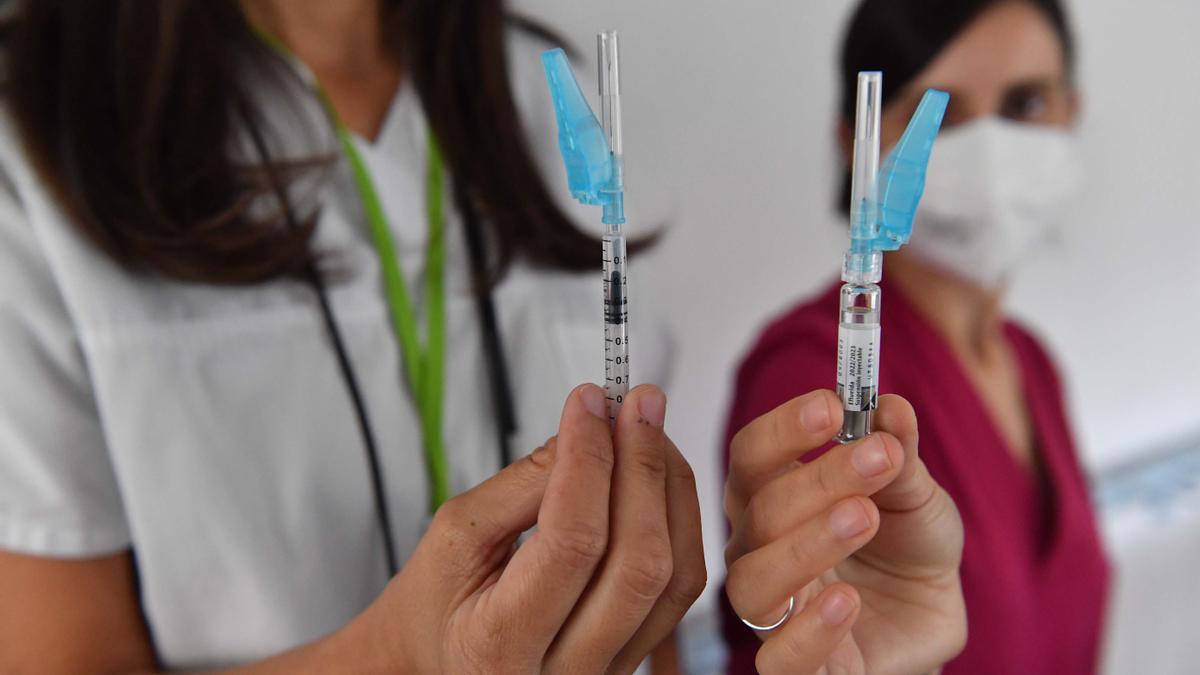 Enfermeras sostienen dos inyecciones con dosis de las vacunas contra el COVID y la gripe, ayer, en la residencia asistida de mayores de Oleiros.