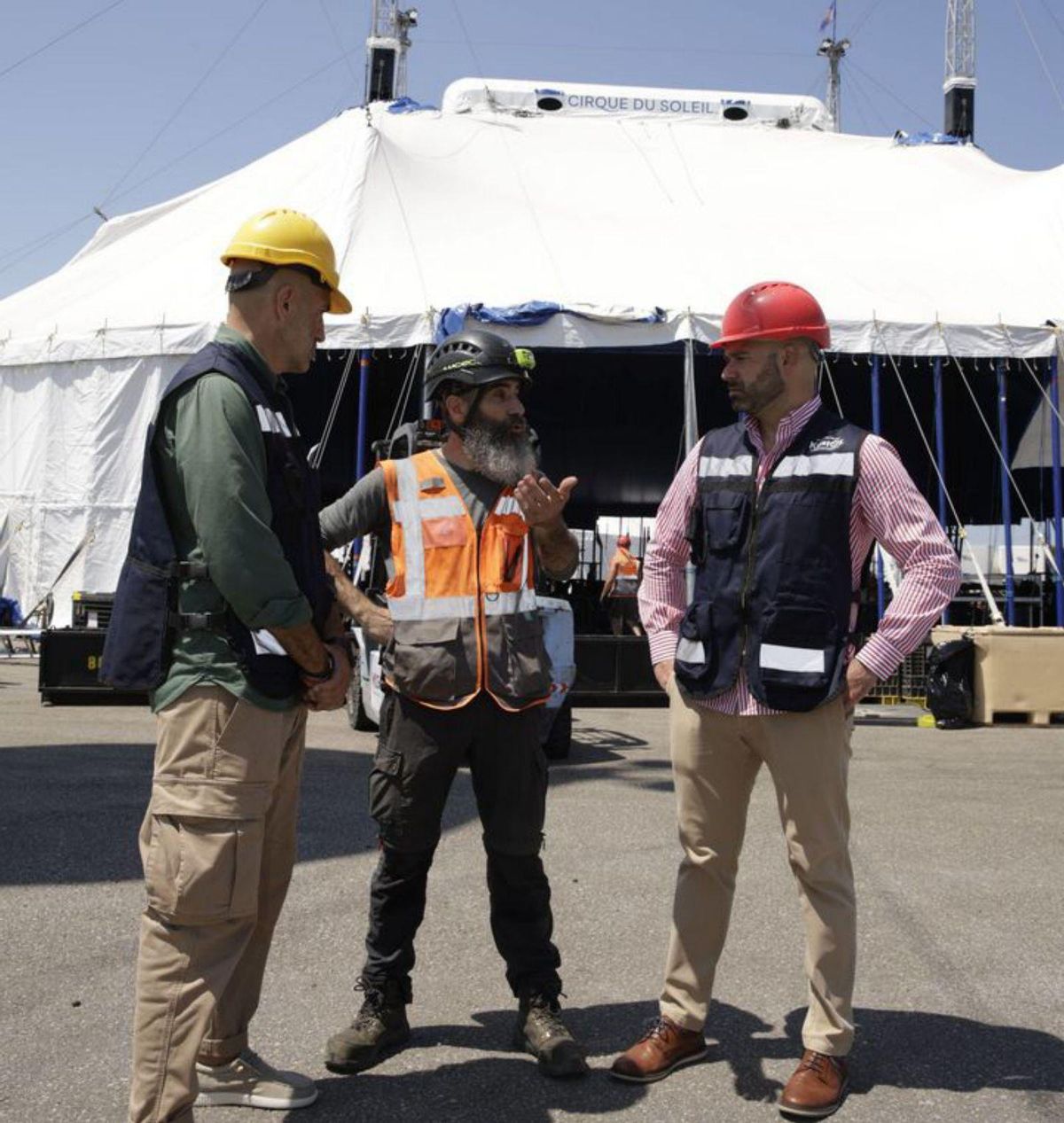 A la izquierda, los trabajadores, durante el montaje de la carpa del Circo del Sol, y a la derecha, desde la izquierda Oliver Suárez, Egoitx Gorbea y Jesús Martínez Salvador, con la carpa del circo ya montada. | JUAN PLAZA
