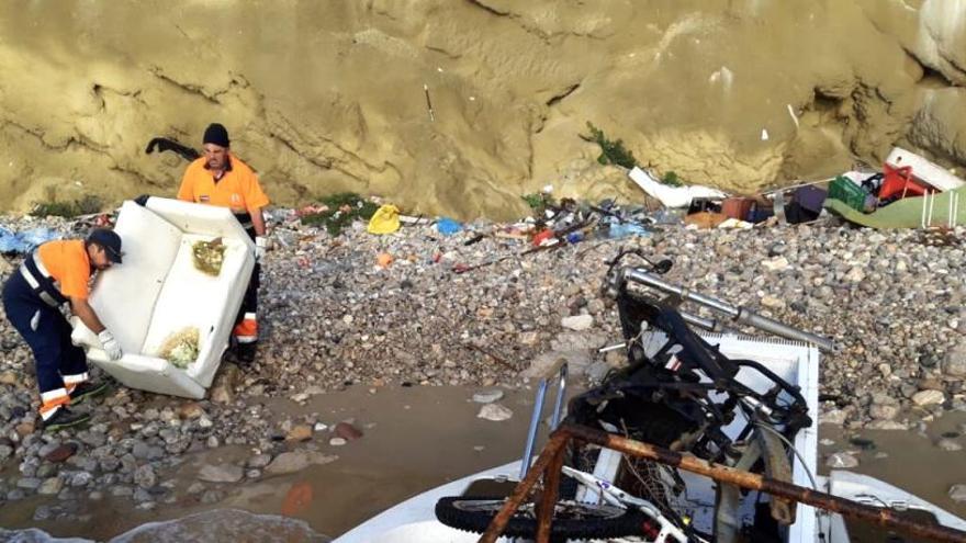 Dos operarios retiran basura en en acantilado de sa Penya.