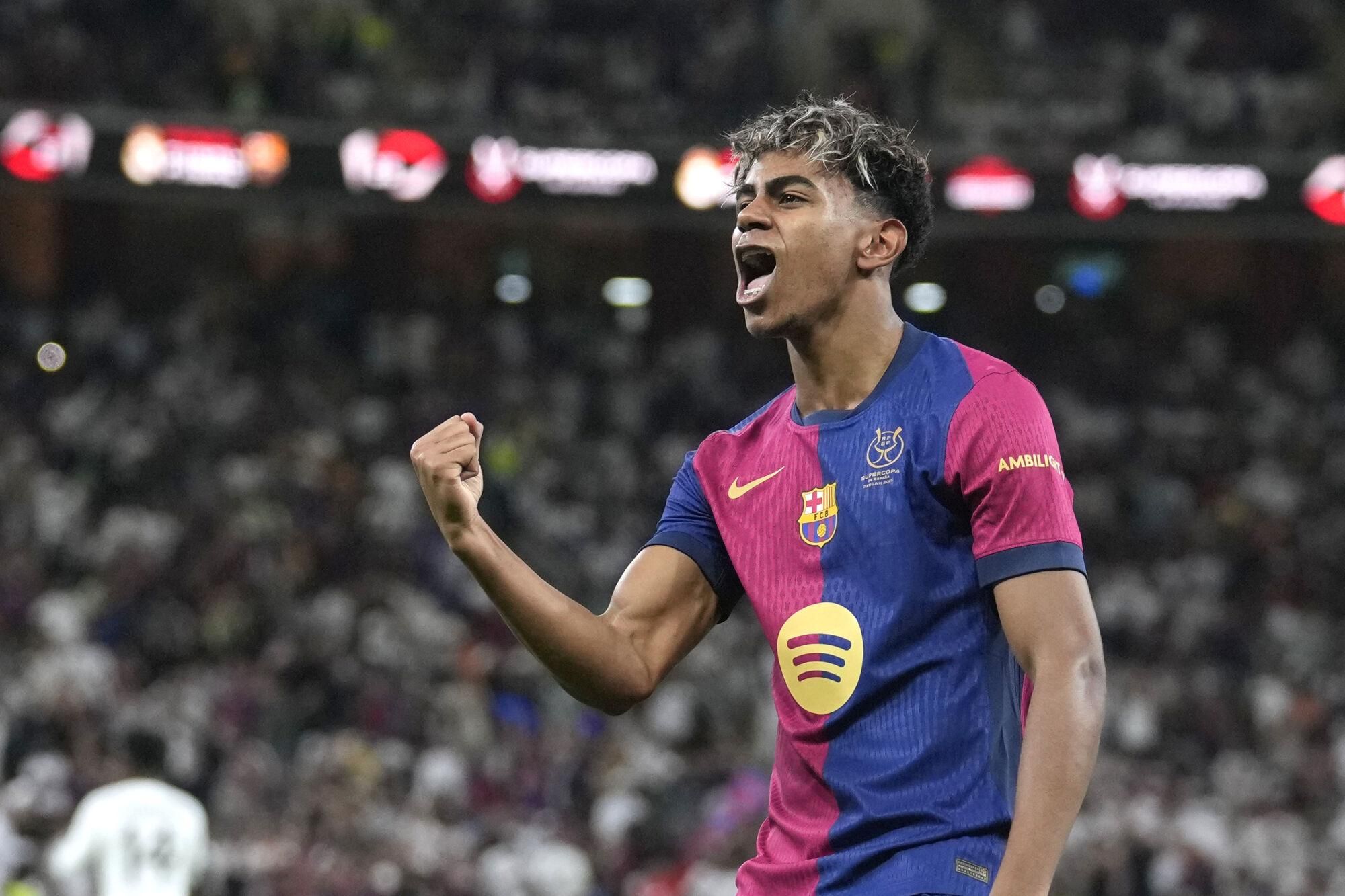 Barcelona's Lamine Yamal celebrates after scoring his side's opening goal during the Spain Super Cup final soccer match between Real Madrid and Barcelona at King Abdullah Stadium in Jeddah, Saudi Arabia, Sunday, Jan. 12, 2025. (AP Photo/Altaf Qadri). EDITORIAL USE ONLY/ONLY ITALY AND SPAIN