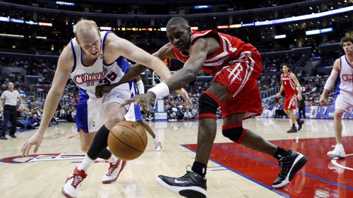 Mutombo, luchando por un balón con Chris Kaman