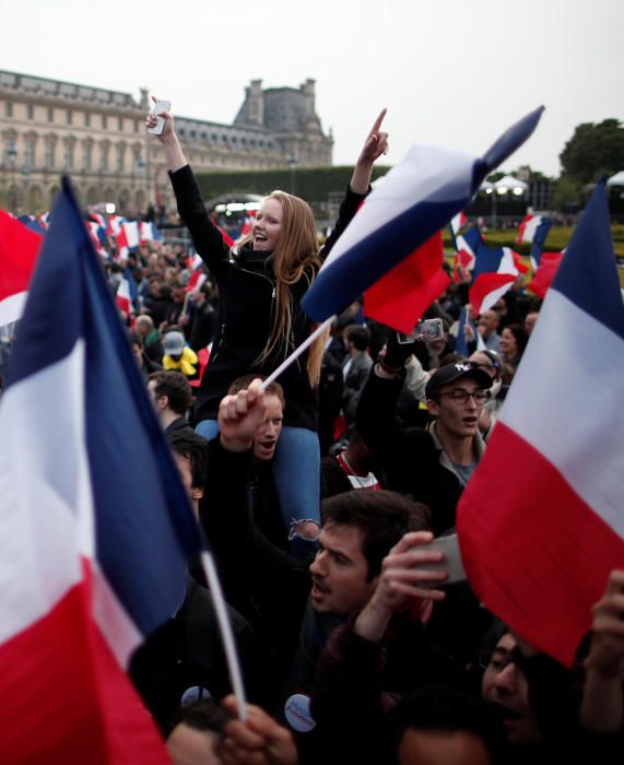 Supporters of Emmanuel Macron celebrate near the ...