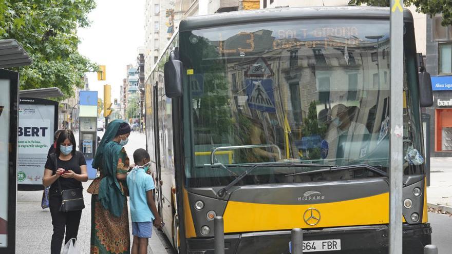 Usuaris de l&#039;autobús a la parada de Marquès de Camps, a Girona, ahir al matí.