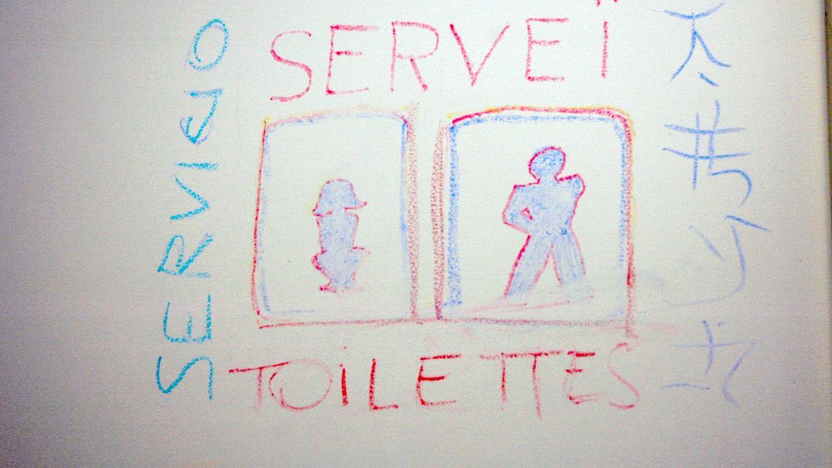 Cartel de unos lavabos en un bar de Barcelona
