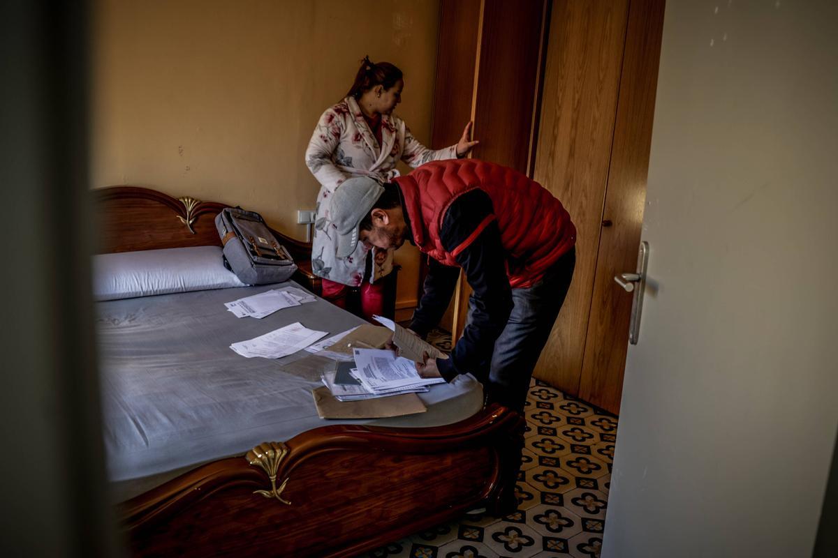 Brahim Bounash y Fatima Boyzgarne, en su habitación revisando toda la documentación que les debe permitir empadronarse.
