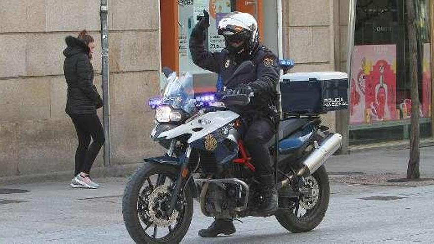 Un policía nacional vigilando la situación en moto. // Iñaki Osorio