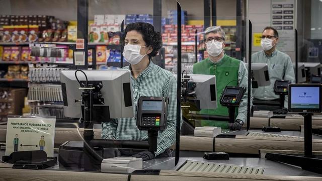 Cajeros de Mercadona con mascarillas y tras unas mamparas de protección, el 24 de marzo del 2020 en València