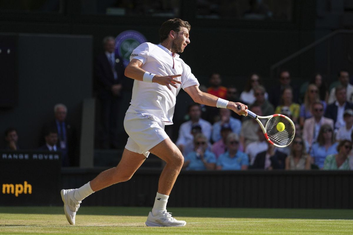 Britains Cameron Norrie returns to Spains Carlos Alcaraz during a quarterfinal mens singles match at the Wimbledon Tennis Championships in London, Tuesday, July 8, 2025. (AP Photo/Kirsty Wigglesworth)