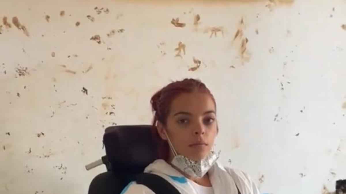 Alba, frente a la línea que mide hasta dónde llegó el agua en su casa de Picanya.