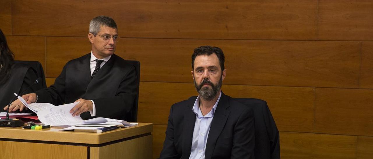 Miguel López sentado en el banquilllo junto a su abogado (a la izquierda) el día que comenzó el primer juicio.