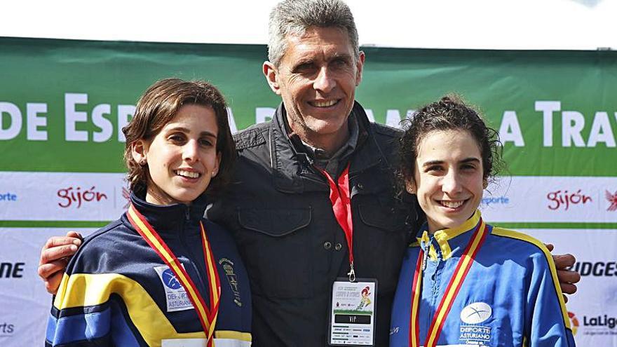 Adelino Hidalgo, entre las atletas Paula González y Lucía Álvarez. | Efe