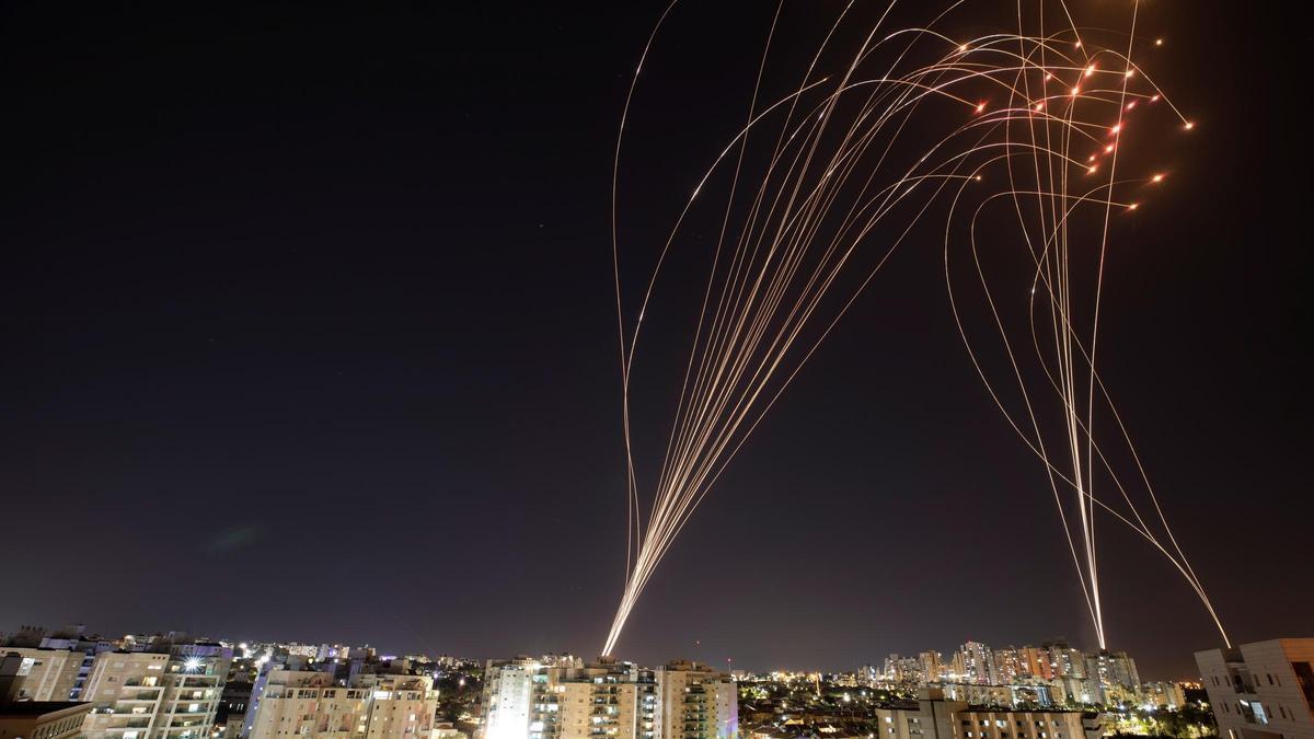 Streaks of light are seen as Israel's Iron Dome anti-missile system intercepts rockets launched from the Gaza Strip towards Israel, as seen from Ashkelon, Israel