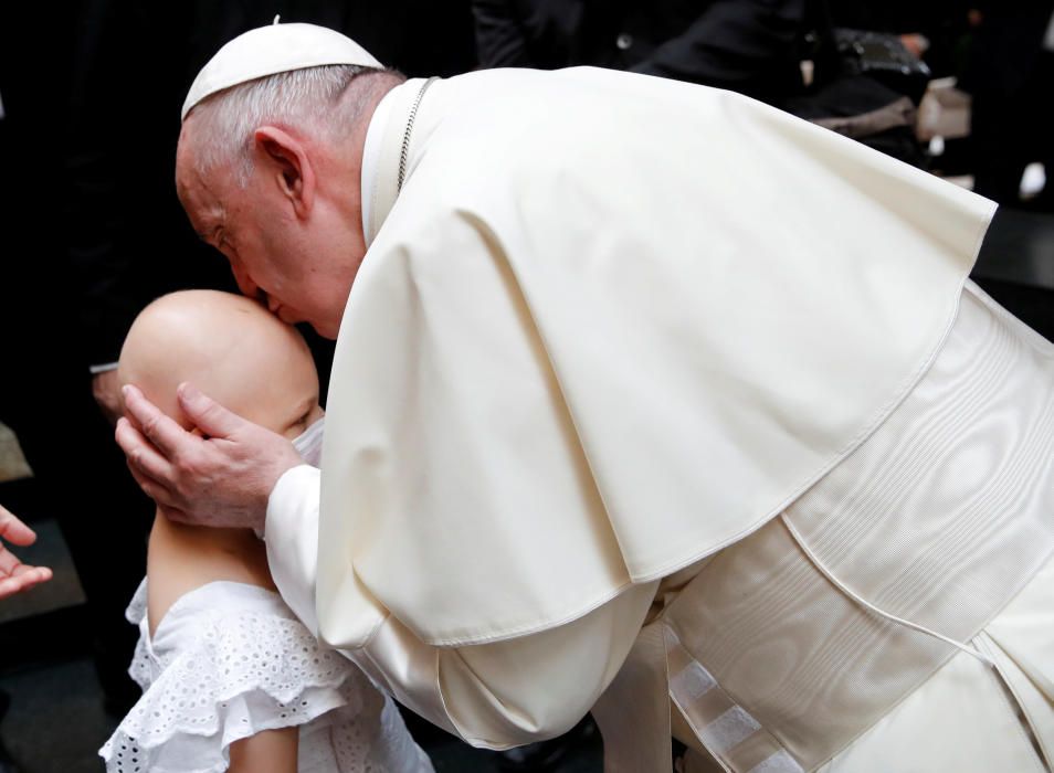 Pope Francis kisses a girl after an ecumenical ...