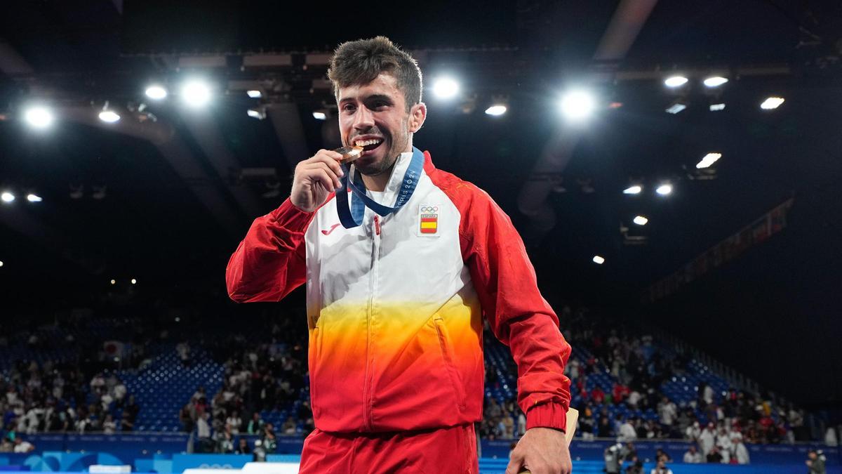 El judoka Francisco Garrigós muerde su medalla de bronce tras finalizar tercero en la prueba de judo masculino de -60 kg, durante los Juegos Olímpicos de París 2024