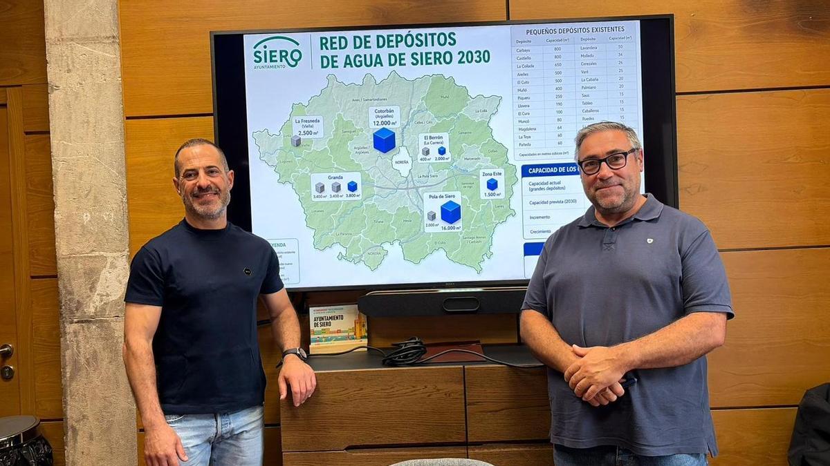 Ángel García, "Cepi", este viernes, con Pergentino Martínez, con el mapa de la red de depósitos de Siero.