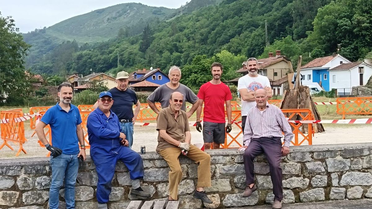 Los miembros de la asociación cultural con la hoguera preparada detrás.