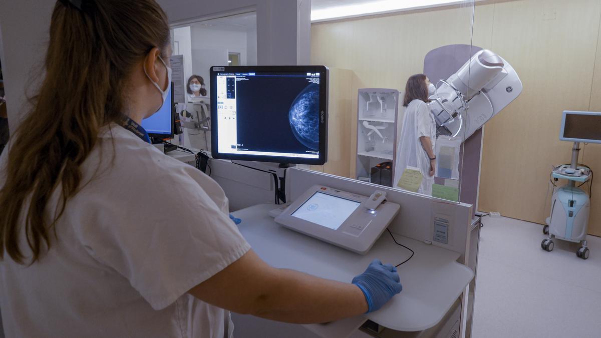 Una sanitaria revisa una mamografía.