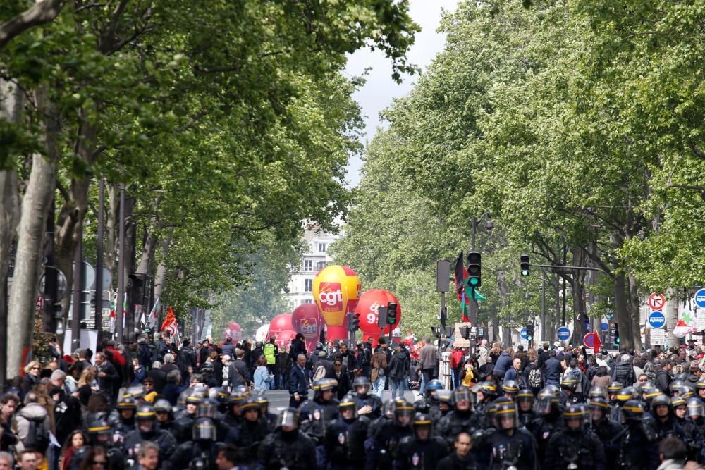 French CRS riot police walk in front of the ...