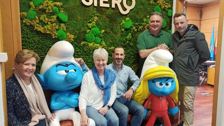 Ángel García, en el centro, con representantes de Los Pitufos y con el modelo de «Pitufina» que se colocará en la Pola, al lado. | LNE