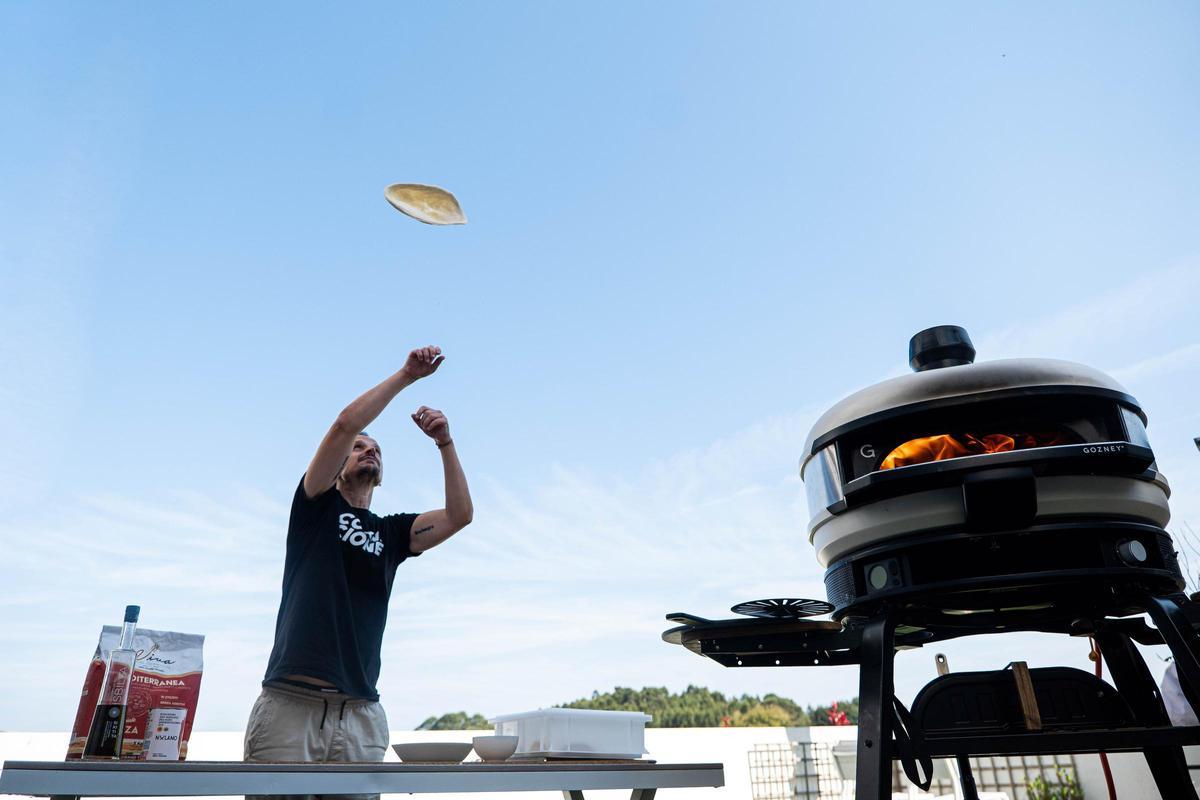 Edu Lavandeira hace volar una masa de pizza.