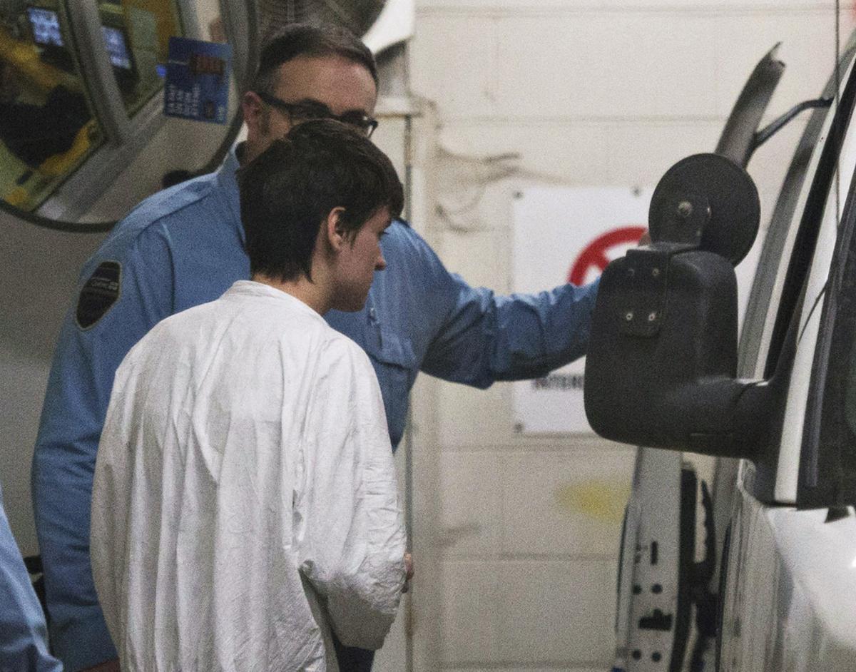 Alexandre Bissonnette is escorted to a van after appearing in court for Sunday’s deadly shooting at a mosque, Monday, Jan. 30, 2017, in Quebec City. The French Canadian suspect known for his far-right, nationalist views was charged Monday with six counts of first-degree murder and five counts of attempted murder in the shooting rampage at the Quebec City mosque that Canada’s prime minister called an act of terrorism again Muslims. (Jacques Boissinot/The Canadian Press via AP)