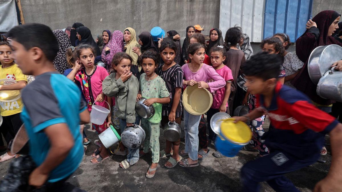 Nens palestins fan fila per a rebre racions de menjar d'una cuina benèfica en Nuseirat, en el centre de la Franja de Gaza, el 30 de setembre de 2025. La imatge es produeix el mateix dia en què el president dels Estats Units, Donald Trump, va presentar el que va qualificar com un “històric” pla de pau per a Gaza, després de gairebé dos anys de guerra.