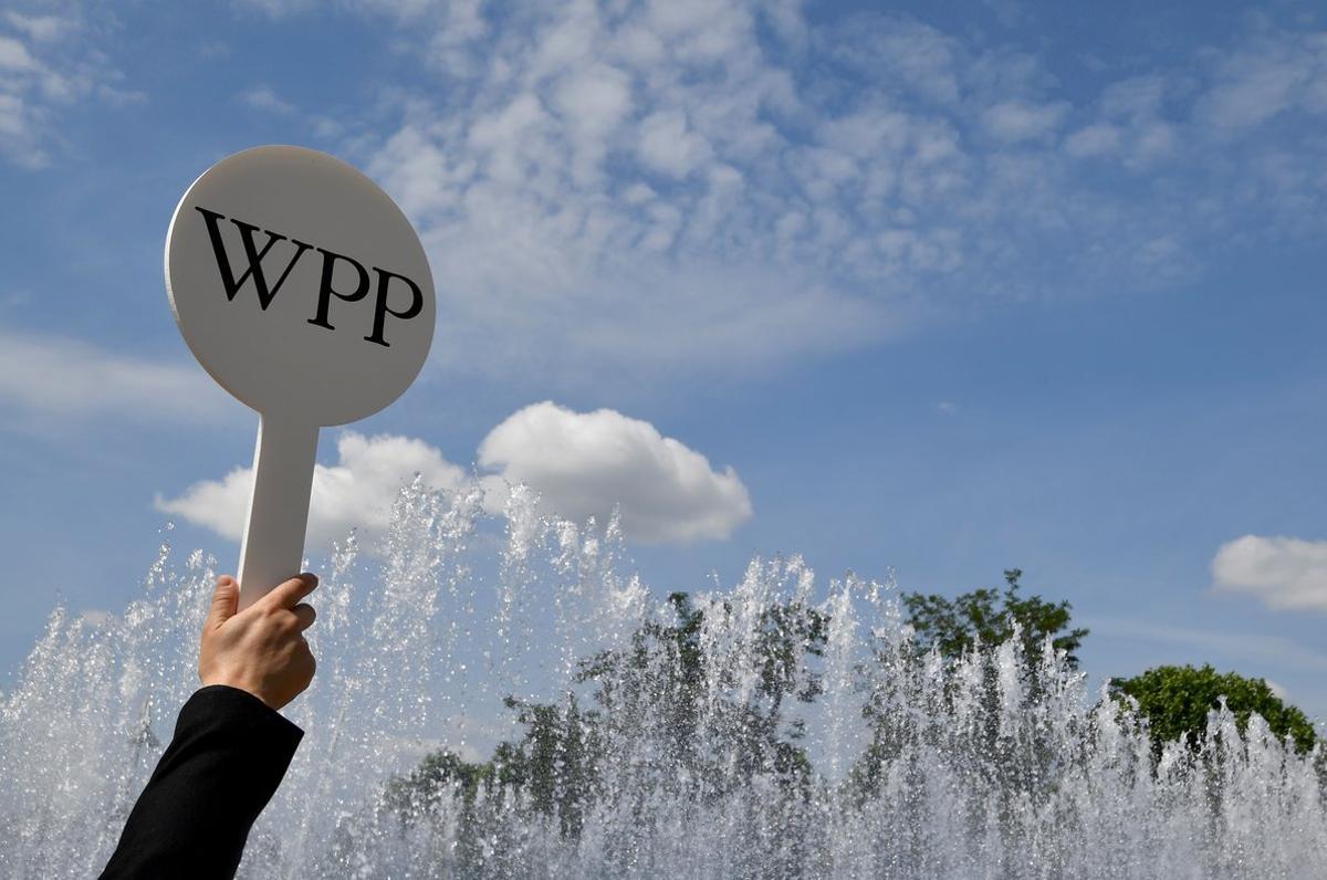 FILE PHOTO: An usher holds a baton to guide attendees towards the AGM of advertising agency WPP in London, Britain, June 13, 2018. REUTERS/Toby Melville/File Photo