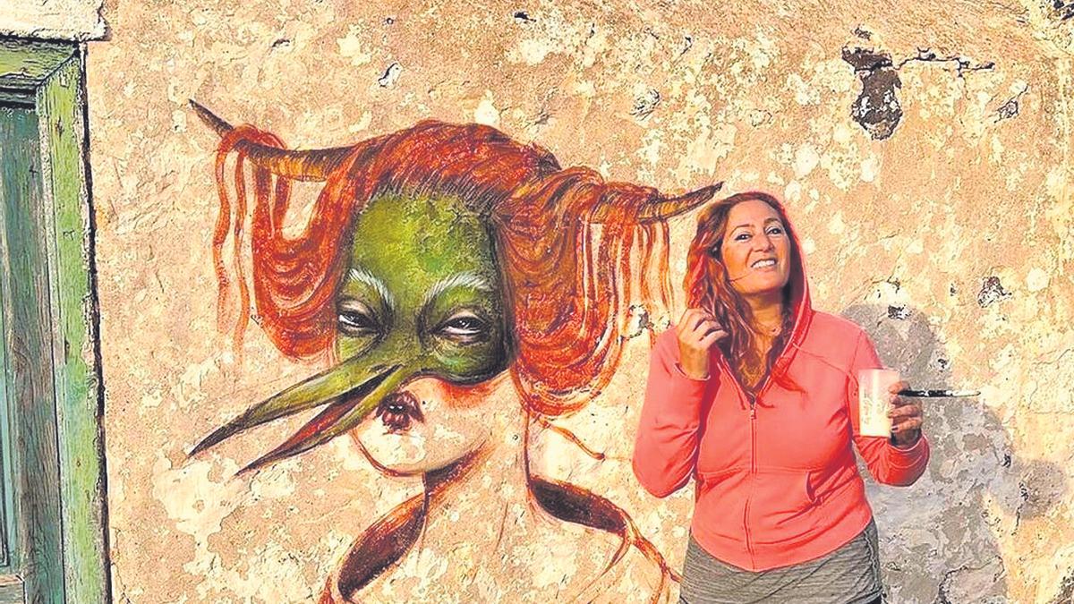 La artista Vanessa Alice posa con su pintura en una casa patrimonial del siglo SVIII en Lanzarote.