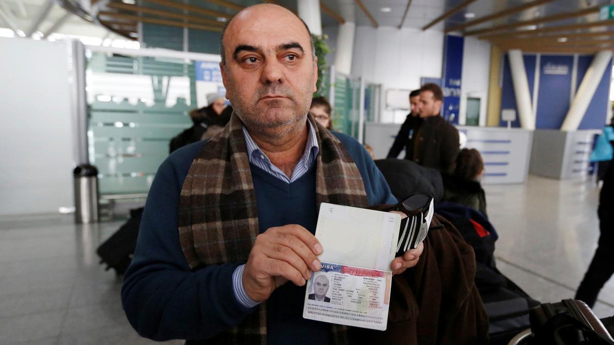 Fuad Sharef Suleman shows his USA visa to the media after returning to Iraq from Egypt, following U.S. President Donald Trump's decision to temporarily bar travellers from Iraq, at Erbil International Airport