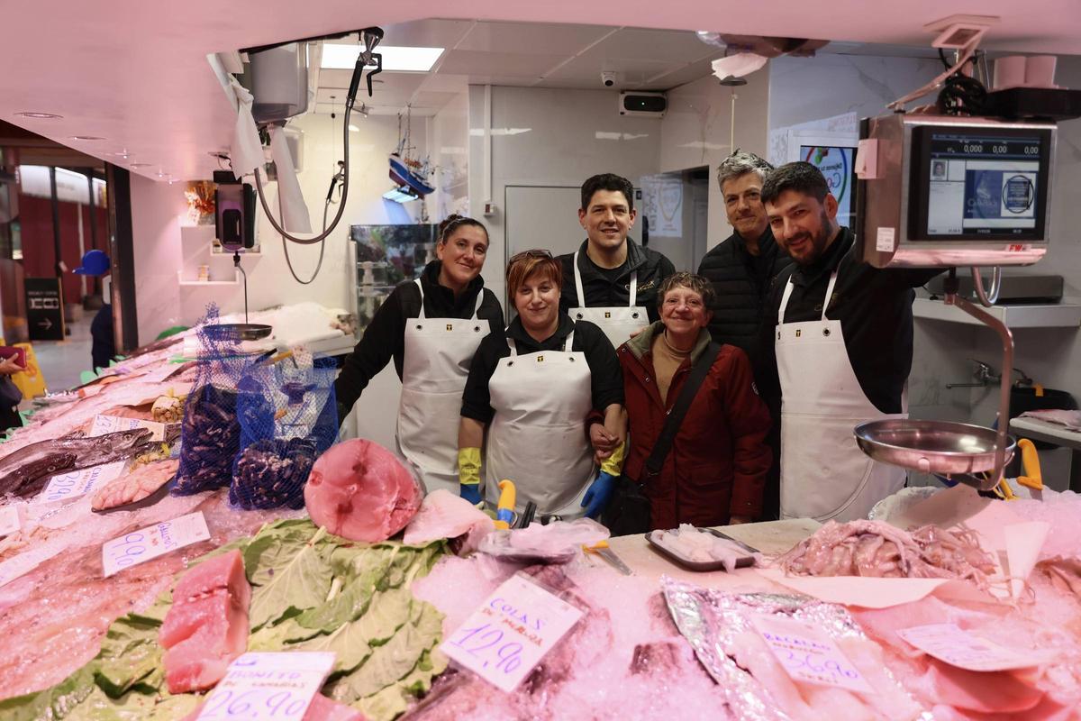 Paloma Fernández y Anabel Iglesias, a la izquierda, e Iván, Paco y Samuel Guillén, a la derecha, rodean a Covadonga Guillén detrás del mostrador.l