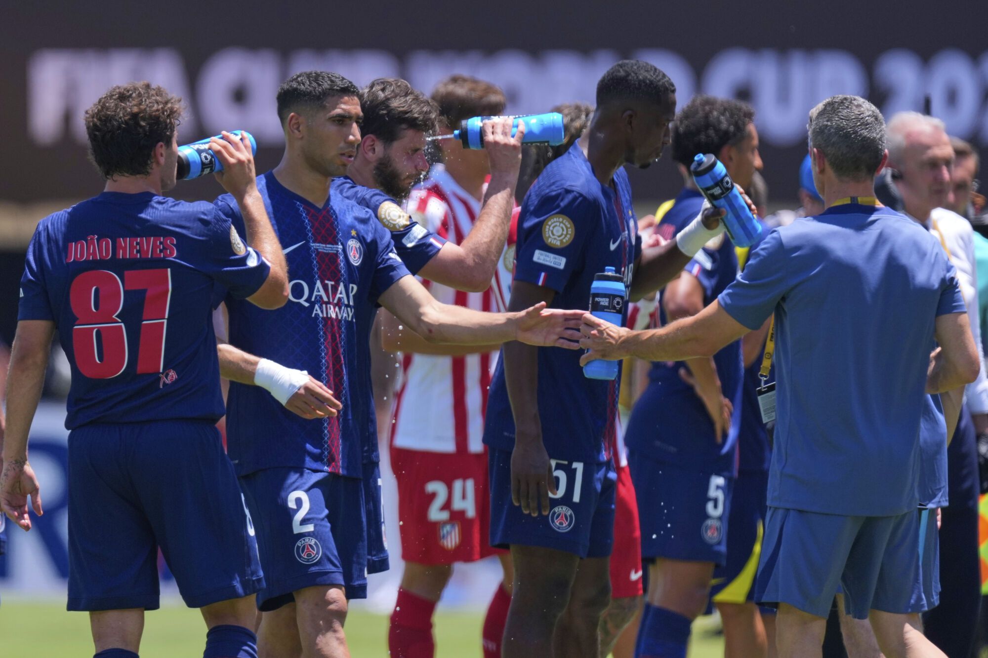 Paris Saint-Germain's players cool off during the Club World Cup group B soccer match between PSG and Atletico Madrid, in Pasadena, Calif., Sunday, June 15, 2025. (AP Photo/Mark J. Terrill)