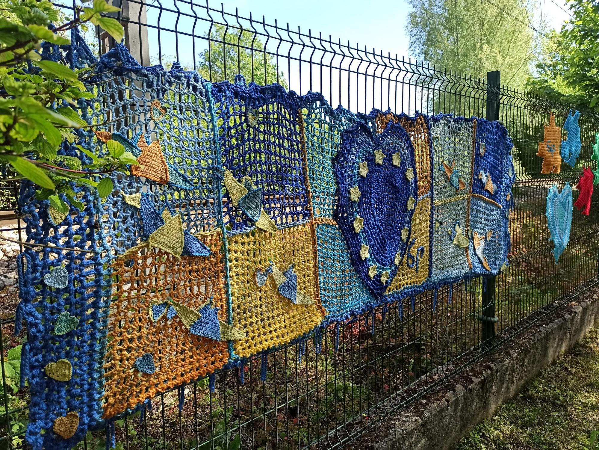 El arte urbano se teje en la Pola, el artista "6p" llena la Senda del Nora de ganchillo: "Si alguien se siente solo, que se sienta más acompañado"